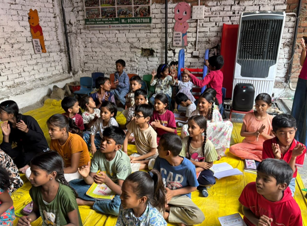 Children participating in a learning session under the covered space